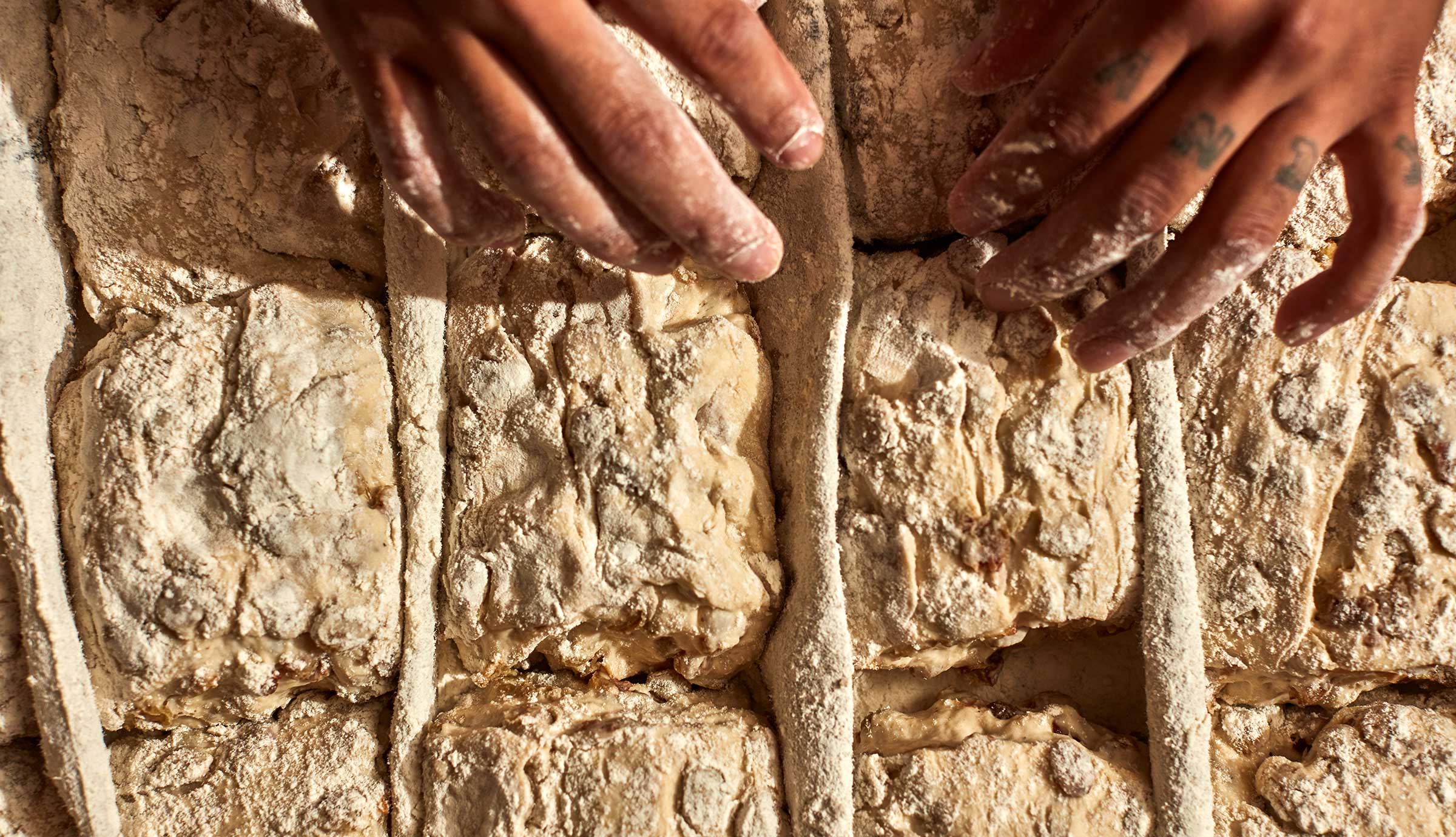 Hands forming bread dough