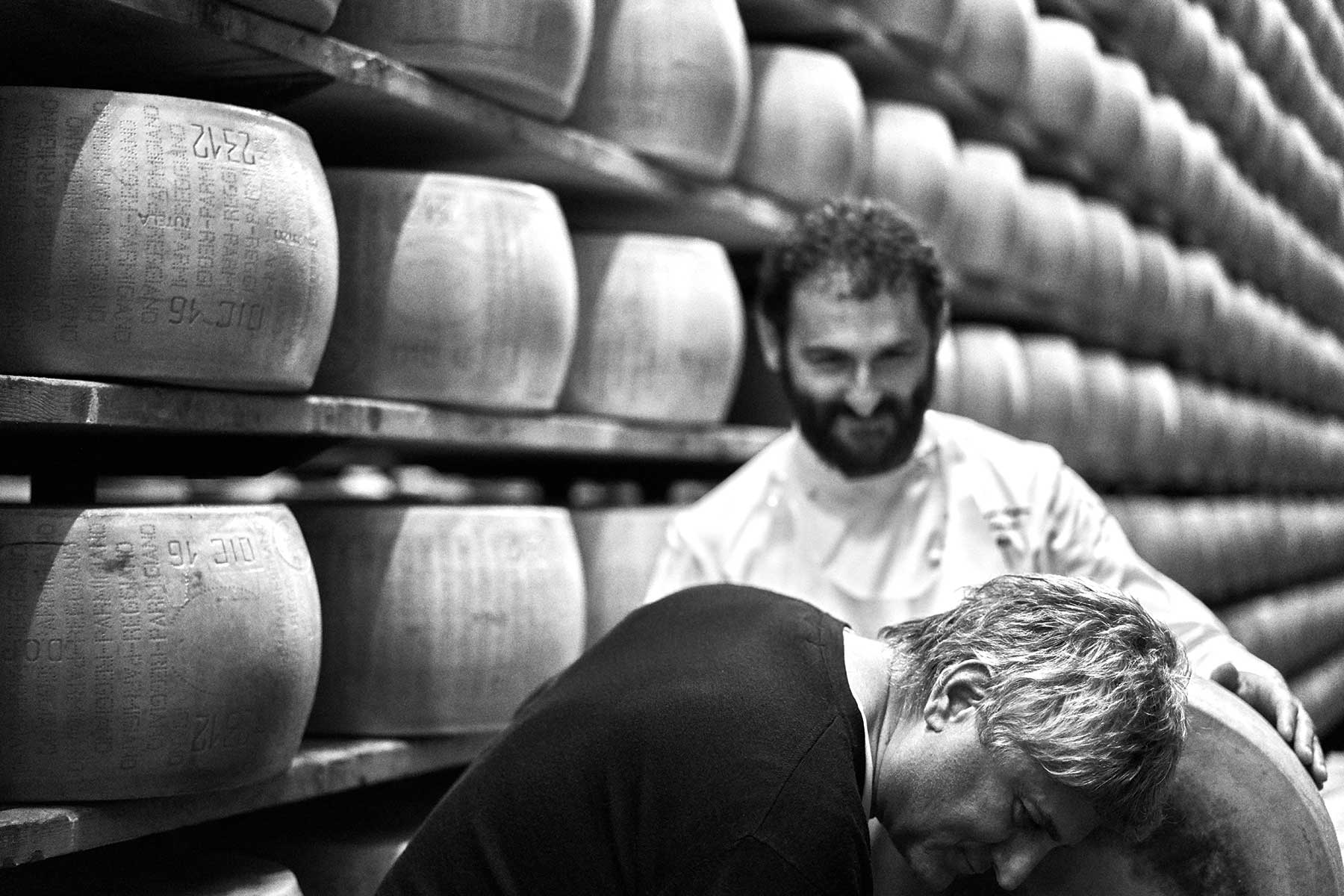 Rocco Princi inspects a wheel of Parmigiano Reggiano cheese