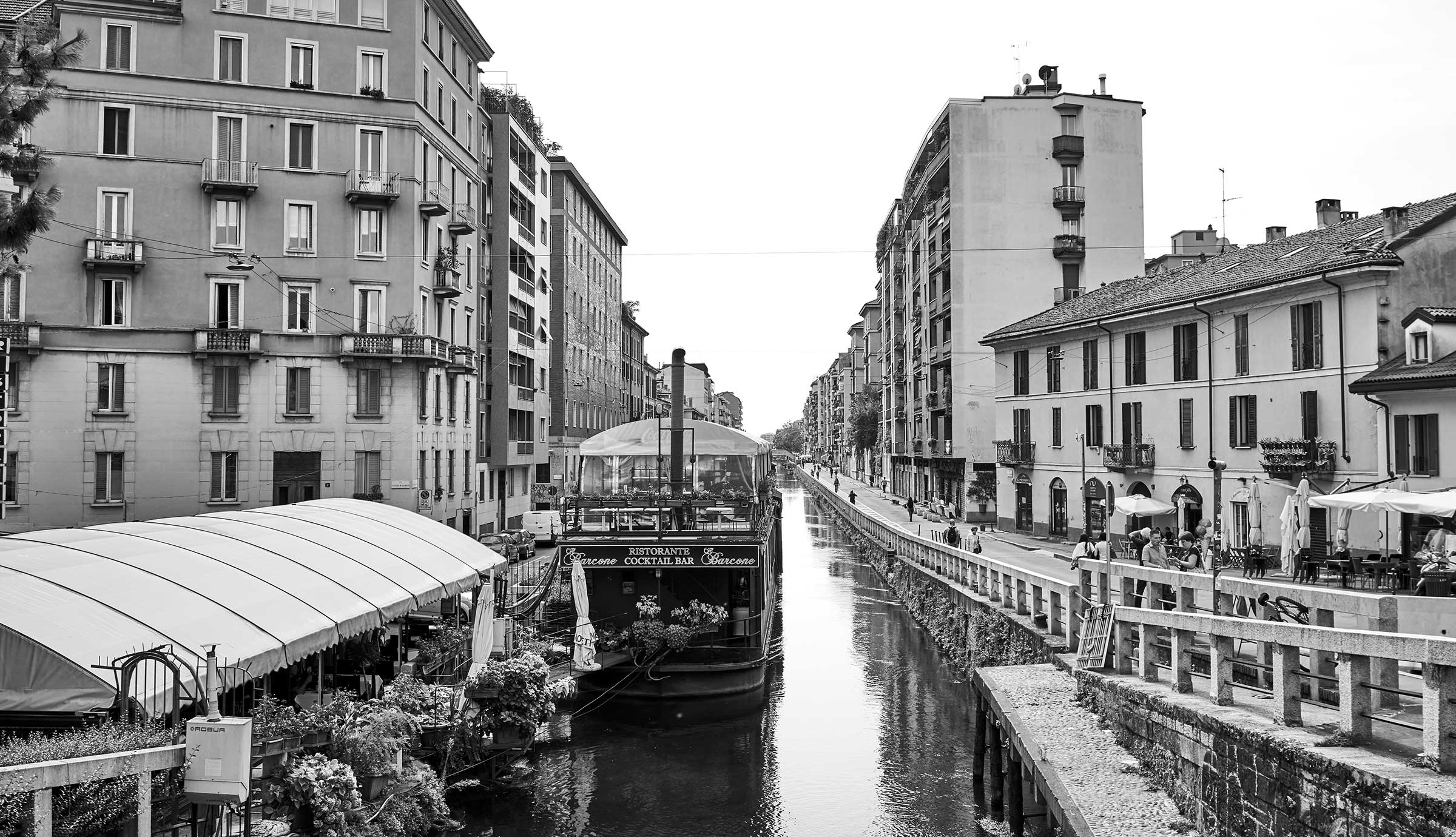 Milan scenery with buildings and boat along a canal